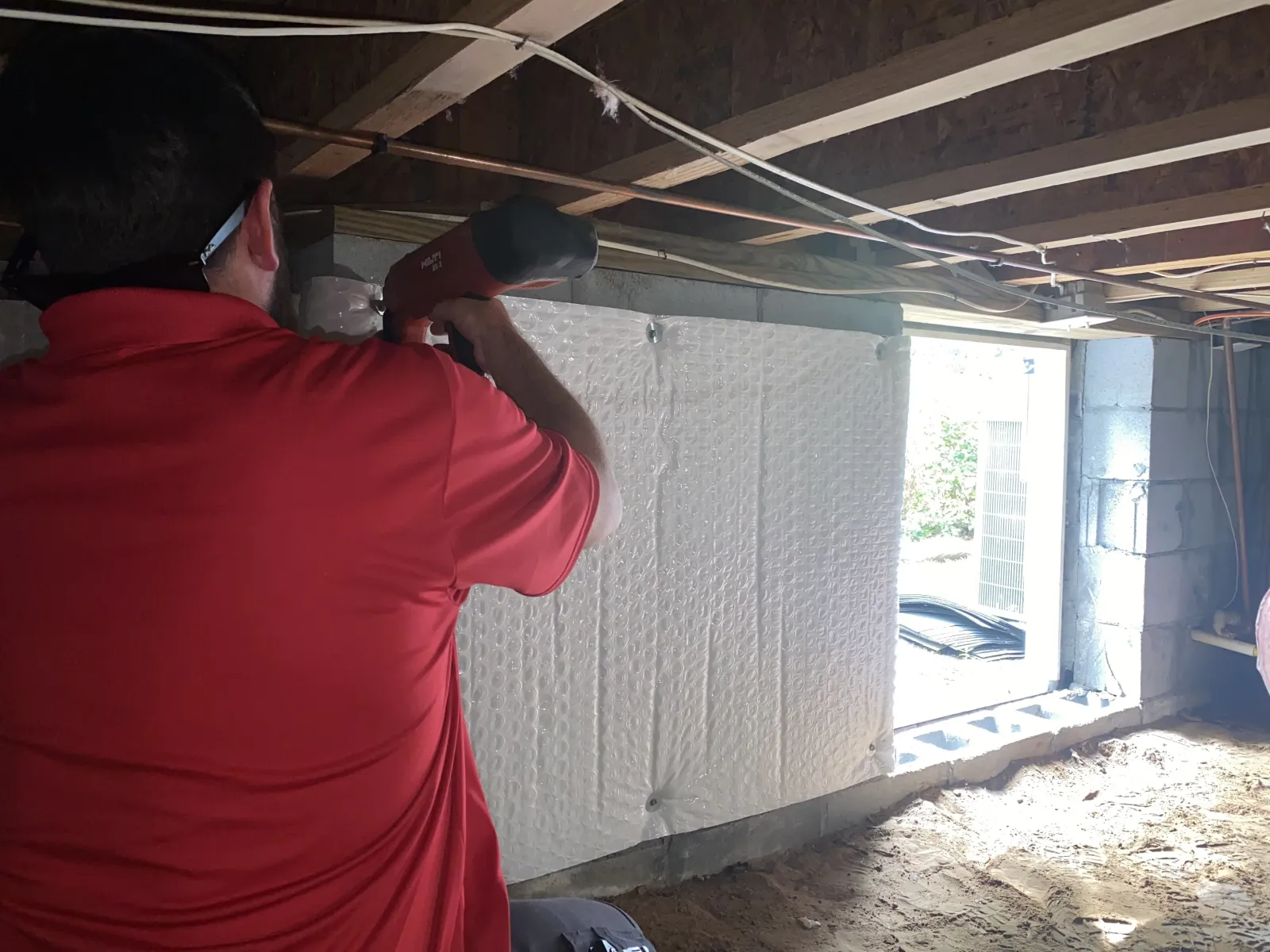 Bug-N-A-Rug technician sealing in the crawl space