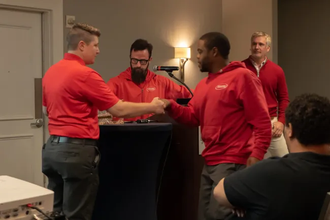 Exterminators shaking hands